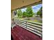 Covered outdoor patio with a wicker rocking chair overlooking a grassy courtyard at 22620 Gage Loop # 25, Land O Lakes, FL 34639