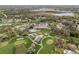 An aerial view highlighting the community's pool, golf course, and well-manicured landscaping at 2436 Deer Trail Ln, Spring Hill, FL 34606