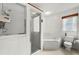 White bathroom featuring a glass shower, large bathtub, neutral tiling, and an exhaust fan at 2436 Deer Trail Ln, Spring Hill, FL 34606