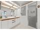 Bright bathroom features double sink vanity, shower with glass door, and great lighting at 2436 Deer Trail Ln, Spring Hill, FL 34606