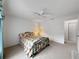 Bedroom with white walls, ceiling fan and a large window allowing in natural light at 2436 Deer Trail Ln, Spring Hill, FL 34606