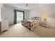 Bedroom features carpet, a ceiling fan, and a large window at 2436 Deer Trail Ln, Spring Hill, FL 34606