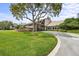 A beautiful clubhouse with a stone facade and lush green lawn at 2436 Deer Trail Ln, Spring Hill, FL 34606
