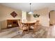 Cozy dining room showcasing wood-look tile flooring, a wooden table with chairs, and soft lighting at 2436 Deer Trail Ln, Spring Hill, FL 34606