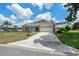View of the front of the home from the street showing the two car garage and brick accents at 2436 Deer Trail Ln, Spring Hill, FL 34606