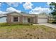 Well-maintained one-story home with brick accents, white trim, and a two-car garage at 2436 Deer Trail Ln, Spring Hill, FL 34606