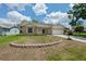 Charming single-Gathering home with brick accents, a two-car garage, and a well-manicured lawn at 2436 Deer Trail Ln, Spring Hill, FL 34606