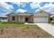 Inviting single-Gathering home featuring brick accents, a two-car garage, and neat landscaping at 2436 Deer Trail Ln, Spring Hill, FL 34606
