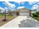Charming single-story home featuring a two-car garage and well-maintained front yard landscaping at 2436 Deer Trail Ln, Spring Hill, FL 34606