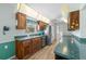 Kitchen with wood cabinets, green countertops, stainless steel fridge, and overhead lighting at 2436 Deer Trail Ln, Spring Hill, FL 34606