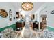 Cozy eat-in kitchen with wood cabinetry, granite countertops, and a charming breakfast nook with a glass table at 2436 Deer Trail Ln, Spring Hill, FL 34606