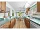 Charming eat-in kitchen features wood cabinets, stainless steel appliances, and a breakfast nook at 2436 Deer Trail Ln, Spring Hill, FL 34606