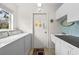 Functional laundry area with a sink, countertop, and white cabinets for ample storage at 2436 Deer Trail Ln, Spring Hill, FL 34606