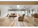 Bright living room with hardwood floors, skylight, ceiling fans, and comfortable seating at 2436 Deer Trail Ln, Spring Hill, FL 34606