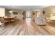 Spacious living room featuring wood-look tile floors, dining area, and comfortable seating at 2436 Deer Trail Ln, Spring Hill, FL 34606