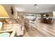 Inviting living room featuring neutral walls, wood-look tile floors and comfortable seating at 2436 Deer Trail Ln, Spring Hill, FL 34606