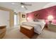 Main bedroom with accent wall, carpet, ceiling fan, and en-suite bathroom entrance at 2436 Deer Trail Ln, Spring Hill, FL 34606