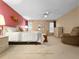 Spacious main bedroom with carpet, ceiling fan, ensuite, and a cozy seating area at 2436 Deer Trail Ln, Spring Hill, FL 34606
