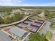 Aerial view of community featuring a newly built set of pickleball courts surrounded by trees at 2436 Deer Trail Ln, Spring Hill, FL 34606