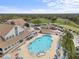 Stunning aerial view showcasing the pool, and other community amenities, under a clear blue sky at 2444 Grandfather Mtn, Spring Hill, FL 34606