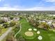 Aerial view of homes in the neighborhood backing onto a sprawling golf course at 2444 Grandfather Mtn, Spring Hill, FL 34606