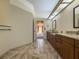 Spacious bathroom featuring double vanities, tile flooring, and access to the bedroom at 2444 Grandfather Mtn, Spring Hill, FL 34606