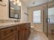 Bathroom featuring a granite vanity, a glass-enclosed shower, tile floors, and updated fixtures at 2444 Grandfather Mtn, Spring Hill, FL 34606
