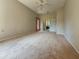 Large bedroom featuring a ceiling fan, neutral carpet, and access to a bathroom and closet at 2444 Grandfather Mtn, Spring Hill, FL 34606