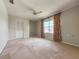 Spacious bedroom with plush carpeting, ceiling fan, and bright window at 2444 Grandfather Mtn, Spring Hill, FL 34606