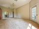 Bright bedroom showcasing neutral carpet, a ceiling fan, and access to a bathroom and outdoor area at 2444 Grandfather Mtn, Spring Hill, FL 34606