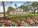 Entrance sign for 'The Country Club of the Pines' adorned with flowers and manicured bushes at 2444 Grandfather Mtn, Spring Hill, FL 34606