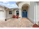 Inviting front entrance with brick pavers, seating area and a bright blue front door at 2444 Grandfather Mtn, Spring Hill, FL 34606