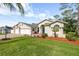 Charming single-story home with a well-manicured lawn, colorful landscaping, and a two-car garage at 2444 Grandfather Mtn, Spring Hill, FL 34606
