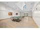 Bright game room with ping pong tables, natural light, and high ceilings at 2444 Grandfather Mtn, Spring Hill, FL 34606