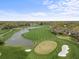 Aerial view of the green golf course, water features and sand traps at 2444 Grandfather Mtn, Spring Hill, FL 34606