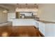 Open kitchen boasts stainless steel appliances, white cabinets, granite counters, and a desk area at 2444 Grandfather Mtn, Spring Hill, FL 34606