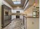 Modern kitchen featuring stainless steel appliances, white cabinetry, granite countertops, and a skylight at 2444 Grandfather Mtn, Spring Hill, FL 34606
