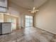 Open-concept kitchen with modern appliances, stone countertops, and access to the sunroom at 2444 Grandfather Mtn, Spring Hill, FL 34606