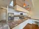 Bright kitchen featuring granite countertops, stainless steel appliances, and a skylight at 2444 Grandfather Mtn, Spring Hill, FL 34606