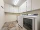 Functional laundry room with modern washer and dryer units and ample cabinet space at 2444 Grandfather Mtn, Spring Hill, FL 34606