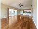 Open floor plan with hardwood floors leading to a screened-in patio and kitchen at 2444 Grandfather Mtn, Spring Hill, FL 34606
