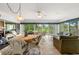 Sunroom with tile flooring, golf course view, and comfortable seating at 2444 Grandfather Mtn, Spring Hill, FL 34606