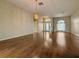 Bright, open-concept living area featuring hardwood floors, elegant lighting, and neutral walls at 2444 Grandfather Mtn, Spring Hill, FL 34606