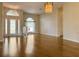Spacious living room featuring wood floors, decorative lighting, and a view of the front entry at 2444 Grandfather Mtn, Spring Hill, FL 34606