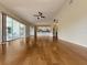 Large living room with hardwood floors, ceiling fan, and open view to the kitchen at 2444 Grandfather Mtn, Spring Hill, FL 34606