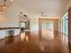 Spacious living room with wood flooring, bright natural light, and an open kitchen at 2444 Grandfather Mtn, Spring Hill, FL 34606