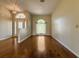Open living room with hardwood floors, arched windows, and natural light streaming throughout at 2444 Grandfather Mtn, Spring Hill, FL 34606