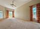 Spacious main bedroom with large windows, plush carpeting, and access to the lanai at 2444 Grandfather Mtn, Spring Hill, FL 34606