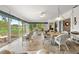 Bright sunroom with tile floors, wicker furniture, and large windows overlooking the green outdoor space at 2444 Grandfather Mtn, Spring Hill, FL 34606