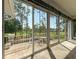 Bright sunroom with stone tile, multiple windows with golf course views at 2444 Grandfather Mtn, Spring Hill, FL 34606